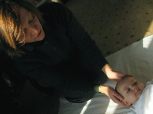 Jennifer Kellow, RN, performing Alexander Technique on a baby